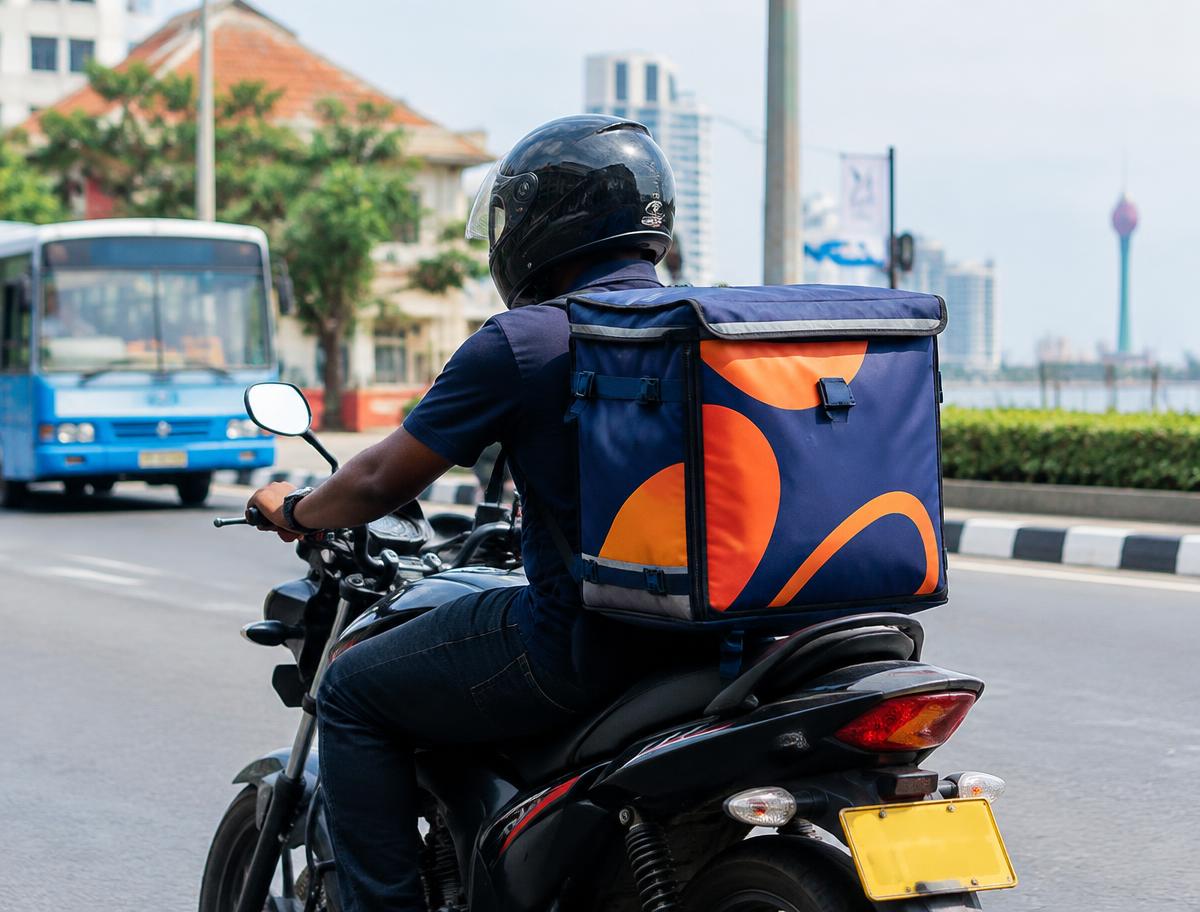 Illustrative mockup of a motorcycle rider carrying a branded insulated delivery bag